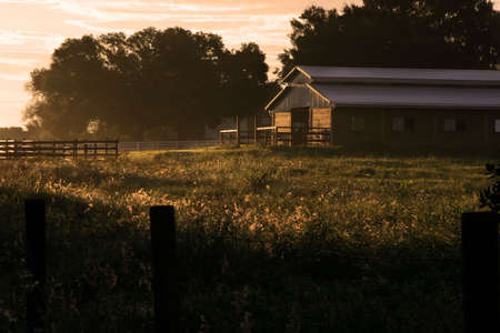 barn glistening at sunriseの写真素材