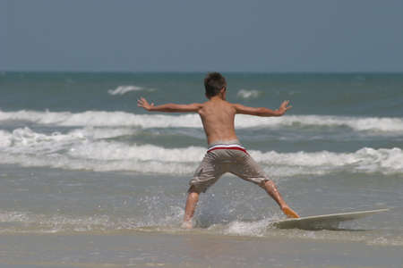 young boy on surf boardの写真素材