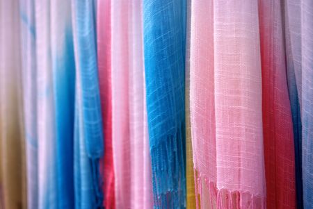 Close up of Colorful Woven Scarves hanging in a row at a market.の写真素材