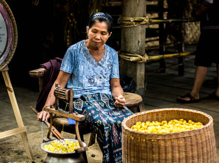 The unidentified woman is filaturing the silk.のeditorial素材