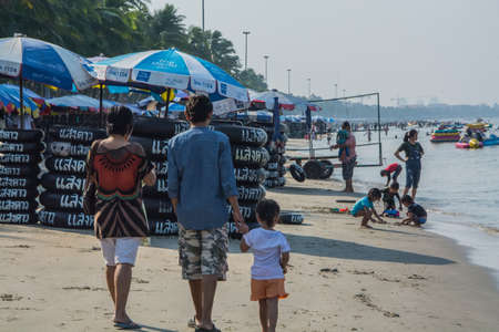 Chonburi Thailand  April 14 2015: Fathermother and son relax at beach in songkran festival.のeditorial素材