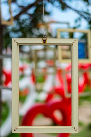 A picture frame hang on tree.の写真素材