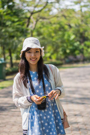 The cute Asian girl in park.の写真素材