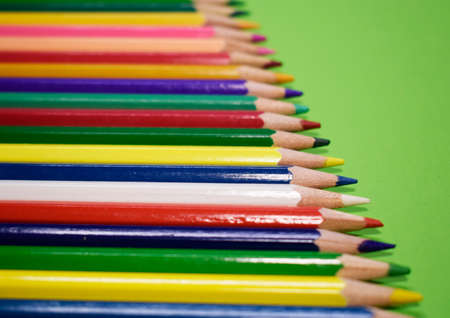 Closeup colorful pencil on green paper backgroundの写真素材