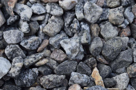 Gravel Rock Texture. Crushed stone and gravel on the ground. Texture background brown stones on a...