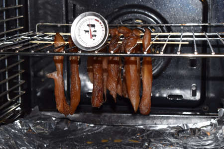 Soft focus. Smoked ham in the oven. Production in the oven smokehouse. Drying in the oven delicacies...