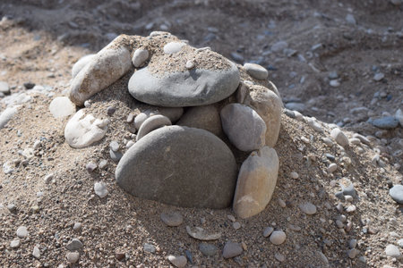 Rocks on the sand beach. Closeup of sand and rocks at a beach