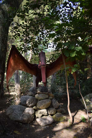 Dinosaur statue in the forest park in nature for background. Realistic model of Pterosaur, Trias- Cretaceous 248-65 million years ago. In the Dinopark, Turkey, Goynuk. Prehistoric era dinosaurの写真素材