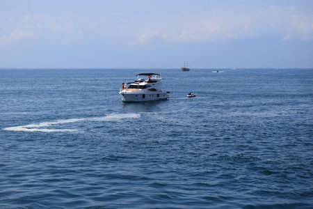 Jetski and yachts on the sea. Clear sea blue sky. Motor transport in the sea, scutter and boats....