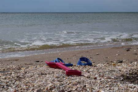 Beach background with flip flop and plastic spade. holidays and vacation concept.の写真素材