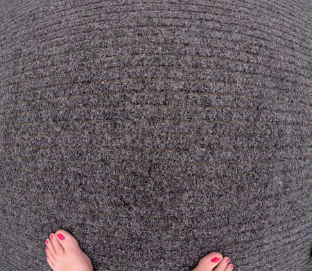 Womans feet on office carpet textureの写真素材