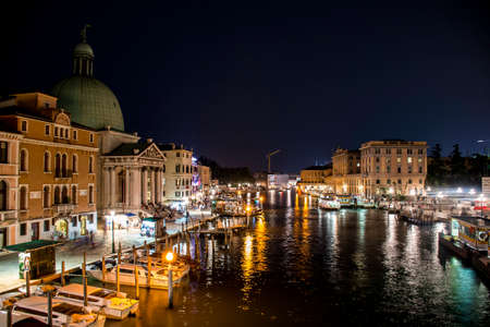 The big canal gondola and boats in romantic Venice in Italy by nightのeditorial素材
