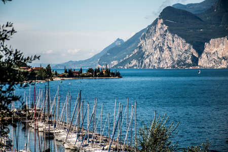 Small Italian town with a harbor full of sailing boats at the Lake Gardaのeditorial素材