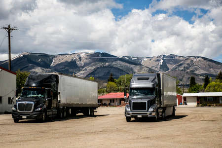 trailer trucks parking in front of Mountains in the west USAの写真素材
