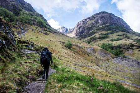 Glen Coe Highlands scotland girl hiking in nature uphill crossing for panorama view 2の写真素材