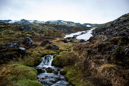 Epic Landscape in Iceland with green grass and snow glacier and Waterfallの写真素材