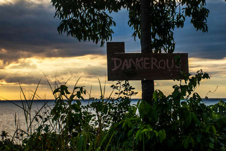 Thailand sunset wooden Sign warning danger zone hillの写真素材
