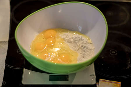 hands making duff pastry of egg in bowl to make fresh waffles