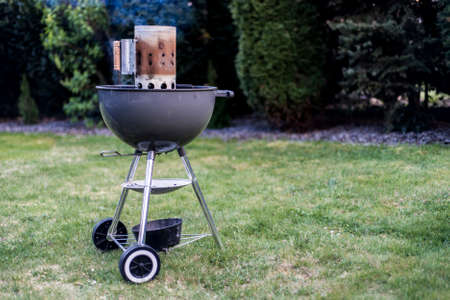 kettle barbecue charcoal grill roasting BBQ standing on gras ready for actionの写真素材