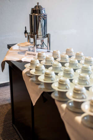 Abstract blurred many rows of coffee tea cups with coffee dispenserの写真素材