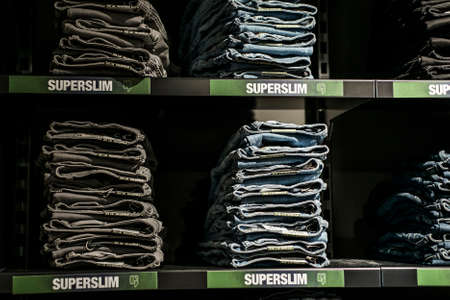 Roermond, Netherlands 07.05.2017 Stack of blue superslim Jeans at the Garcia Store Mc Arthur Glen...