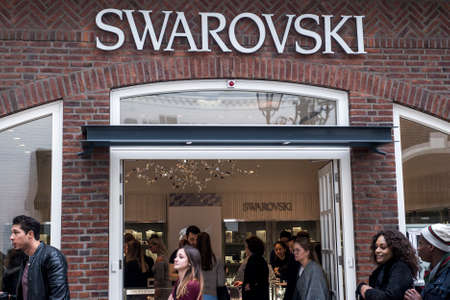 Roermond, Netherlands 07.05.2017 Logo and shop of Swarovski Store Mc Arthur Glen Designer Outlet...