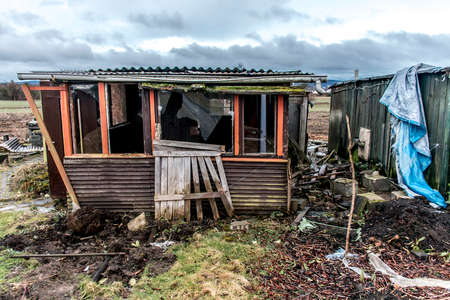 Old creepy dark abandoned destructive dirty house broken windowsの写真素材