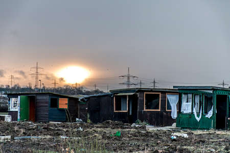 Old creepy dark abandoned destructive dirty house broken windows sunsetの写真素材