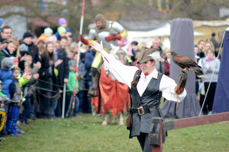 06.04.2015 Lorelay Germany - woman in traditional medieval clothes holding falcon on her arm falcony...
