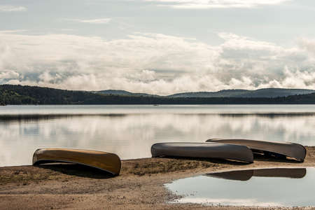 Canada Ontario Lake of two rivers Canoe Canoes parked on beach near water in Algonquin National Parkの写真素材