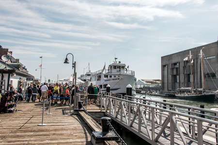 04.09.2017 Boston Massachusetts USA- People everyday life families and boats moored pier long wharf center of Bostonのeditorial素材