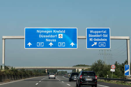 Frankfurt, Germany 29.09.2017 - German highway autobahn blue road sign leading to the airport duesseldorfのeditorial素材