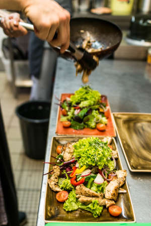 Grilled Chicken Breast fillet with fresh tomatoes vegetables salad. concept healthy food made by a cook in the kitchenの写真素材
