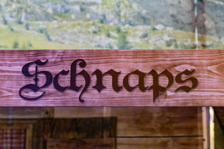wooden signs from a bar at the german oktoberfest referring to shots-schnaps area where people can buy alcoholの写真素材