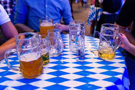 Koblenz Germany -26.09.2018 Close-up of bavarian beer glasses 1 liter bitburger Beer on table...