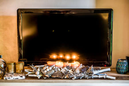 four burning advent candles, beautiful decorated setup and branches light christmas with textspace in TV in Backgroundの写真素材