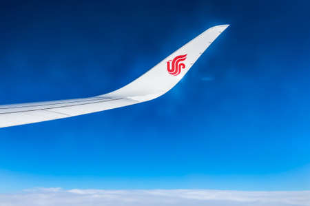 Air China wing of airplane in the sky red winglet blue sky cloudsのeditorial素材