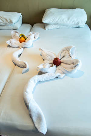 vacation decorative close up a animal made of white towel lies on a bed in Egypt nile cruise boat hotel in Africaの写真素材