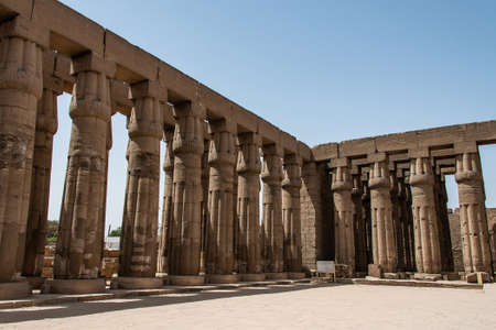Ancient Sculptures and columns hieroglyphs and relief engravings carved into a stone wall at Luxor Temple of Amun-Raの写真素材