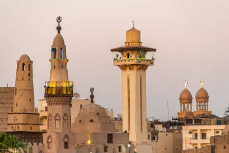 catholic Church and Muslim Mosque Tower religion Symbols together in Luxor temple at sunsetの写真素材