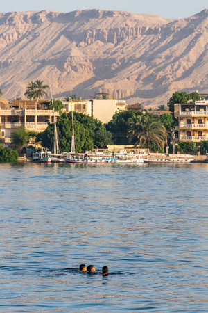 Luxor, Egypt 17.05.2018 View of the Nile river west bank town coastline with sailboats in Luxor,...