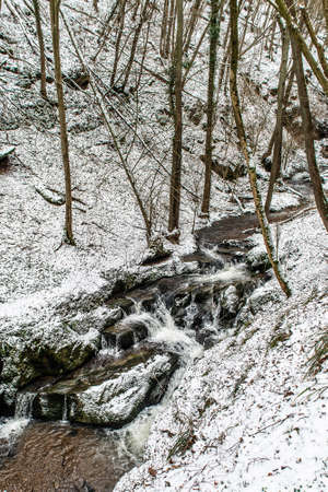 Winter landscape in the german mountains, snowy forest, trees in snow, winter creek, waterfall, nature near brodenbachの写真素材