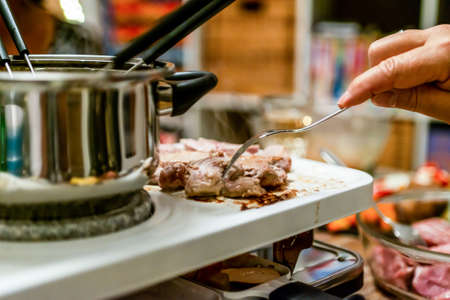 Swiss or Dutch raclette table filled with ingredients for a celebratory evening like Christmas or...