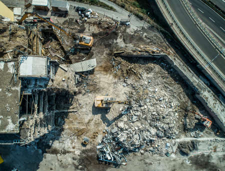 Building House Demolition site Excavator with hydraulic crasher machine and yellow containerの写真素材