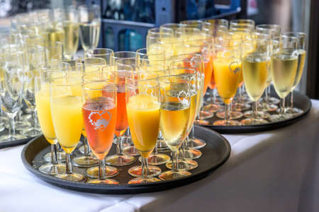 sparkling wine in glasses with orange juice in restaurant or wedding party dinner setting