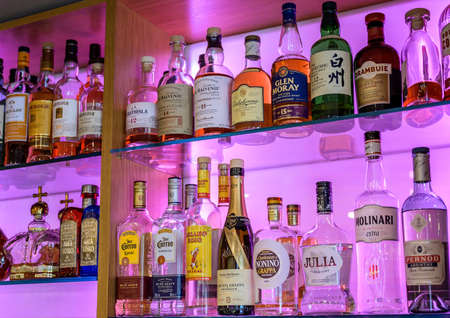 Grenzau Germany 27.07.2019 - Bitters and liquor bar counter with different bottles vintage style ambient lightのeditorial素材