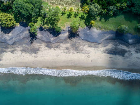 Aerial shot of wedding dress couple on the tropical beach Playa Arenillas in Costa Rica with a heart drawn into Sandの写真素材