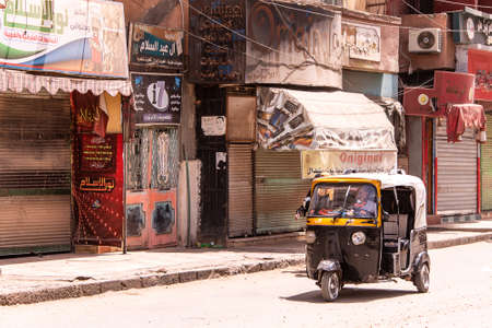 EDFU EGYPT19.05.2018 The tuk-tuk taxi, a popular transportation vehicle in Egypt driving through...