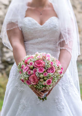 Wedding bouquet of flowers held by bride closeup. Pink flowerの写真素材