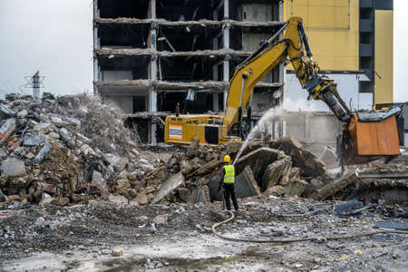 Building House destruction Demolition site Excavator with hydraulic crusher machine ruin house.